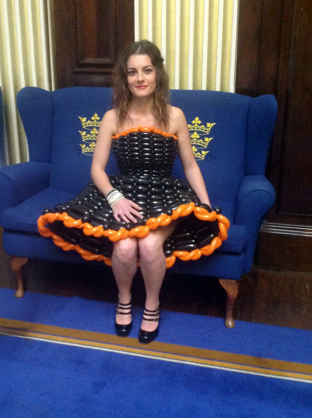 Girl sat in black and orange balloon dress