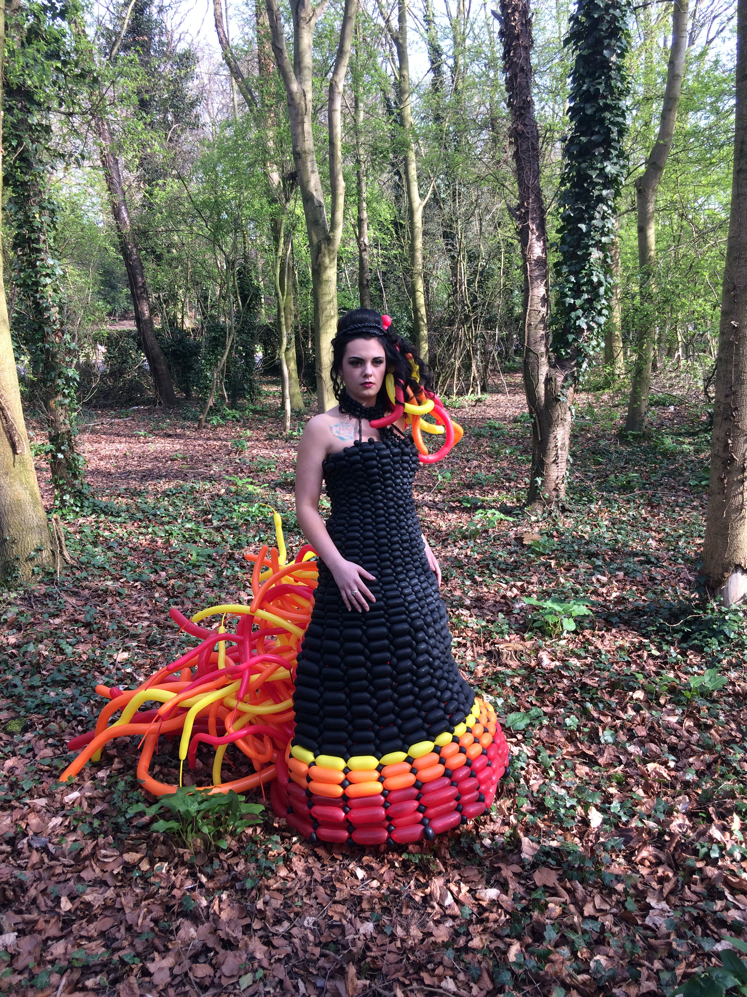 Girl wearing the hunger games dress in a forest