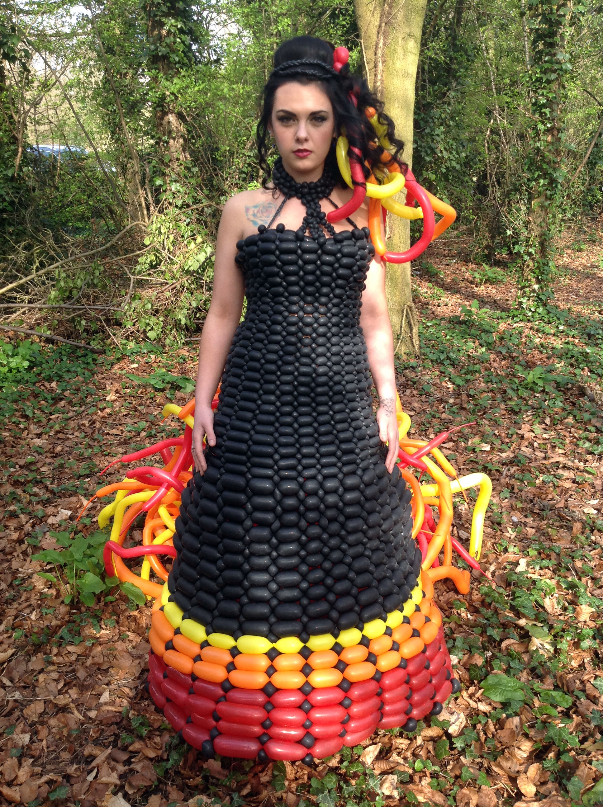 Girl in hunger games balloon dress in the forest