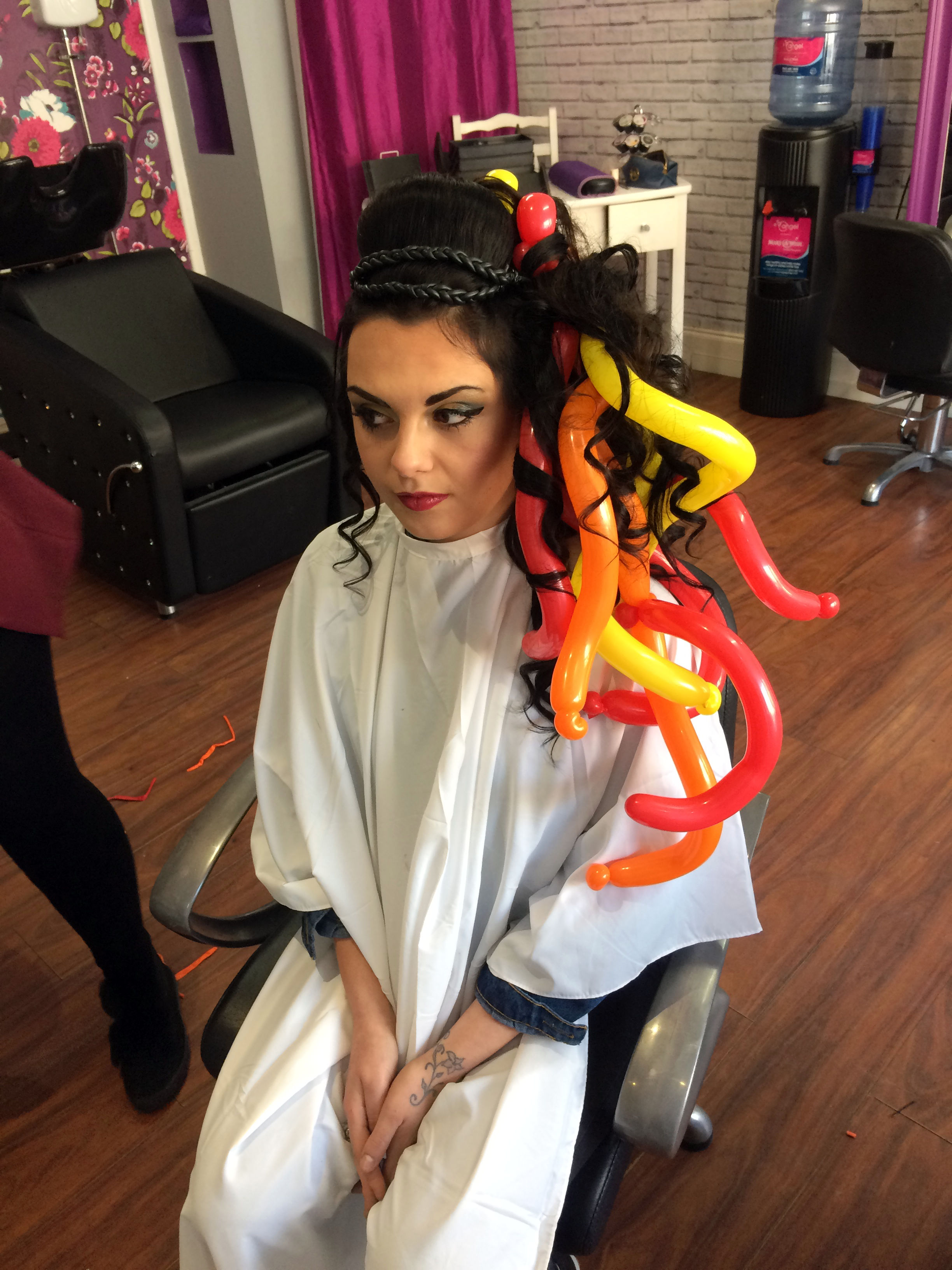 Hunger games model having balloons weaved into hair
