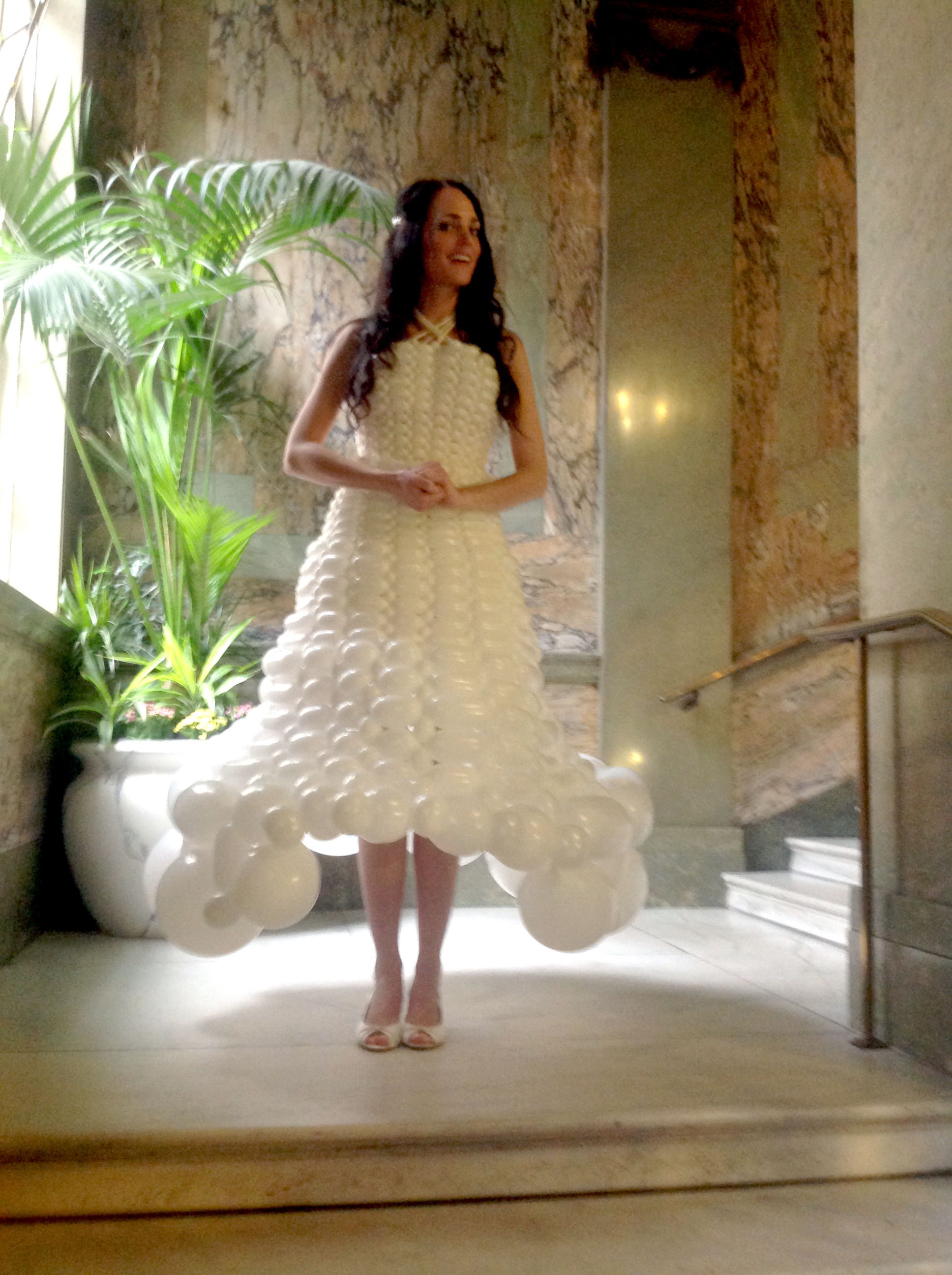 Woman wearing a balloon wedding dress stood on grand staircase